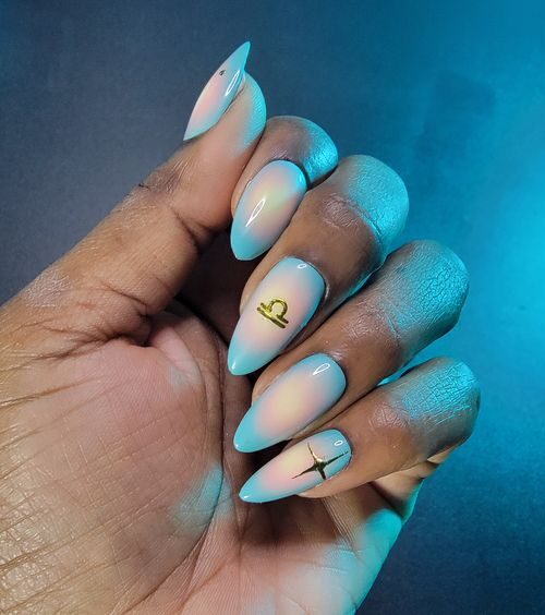 Light blue and nude aura gradient nail art with Libra sign on long almond nails