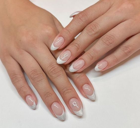 Silver French tips and Libra sign nail art on medium round nails