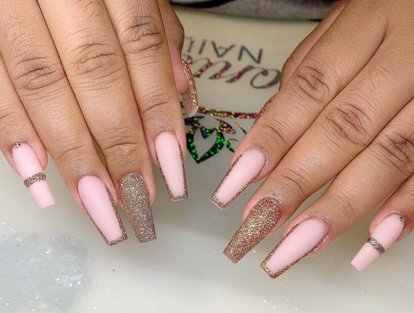 Rose gold glitter thin French tips on long coffin shaped acrylic nails