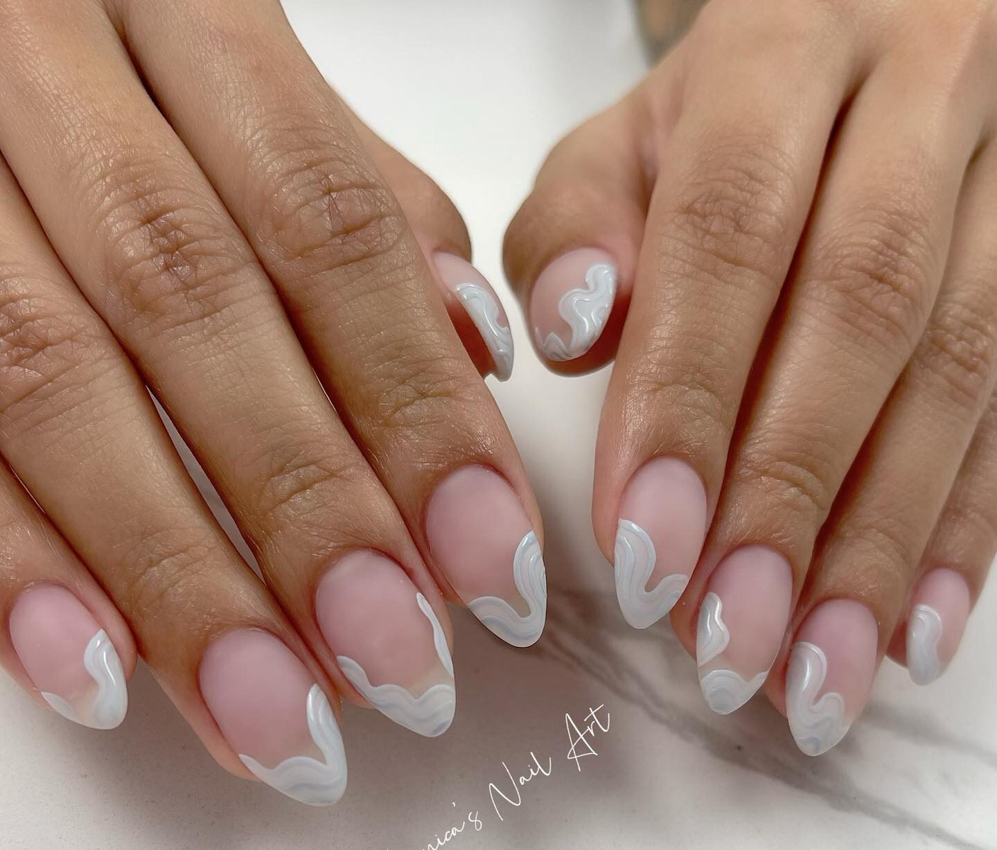 White abstract French tips on long almond shaped acrylic nails