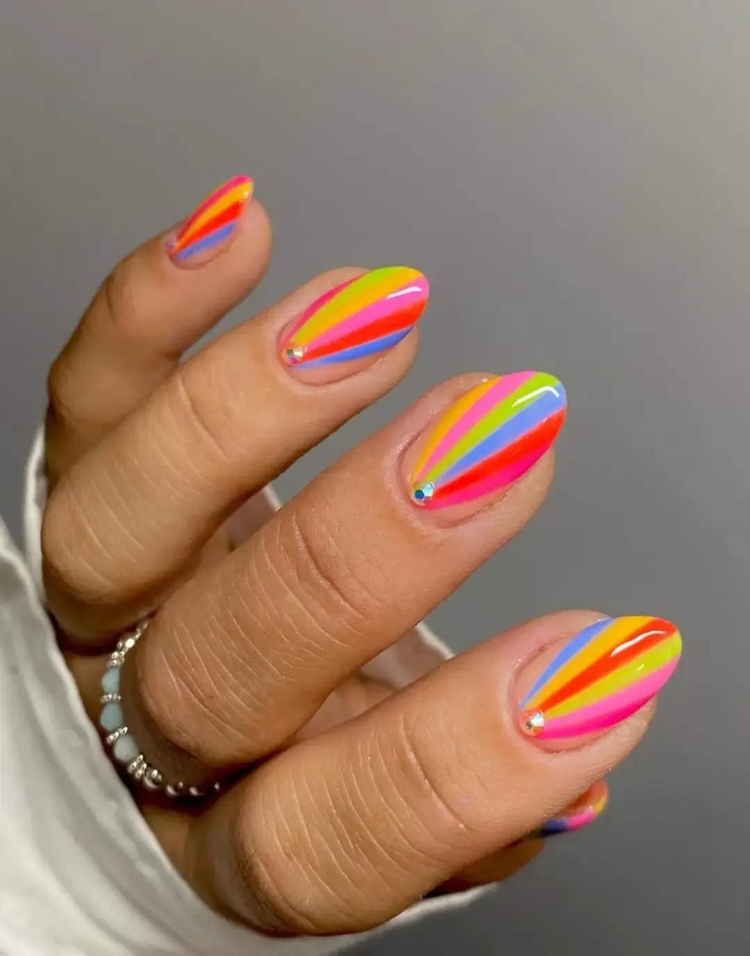 Short rainbow nails with stripes.