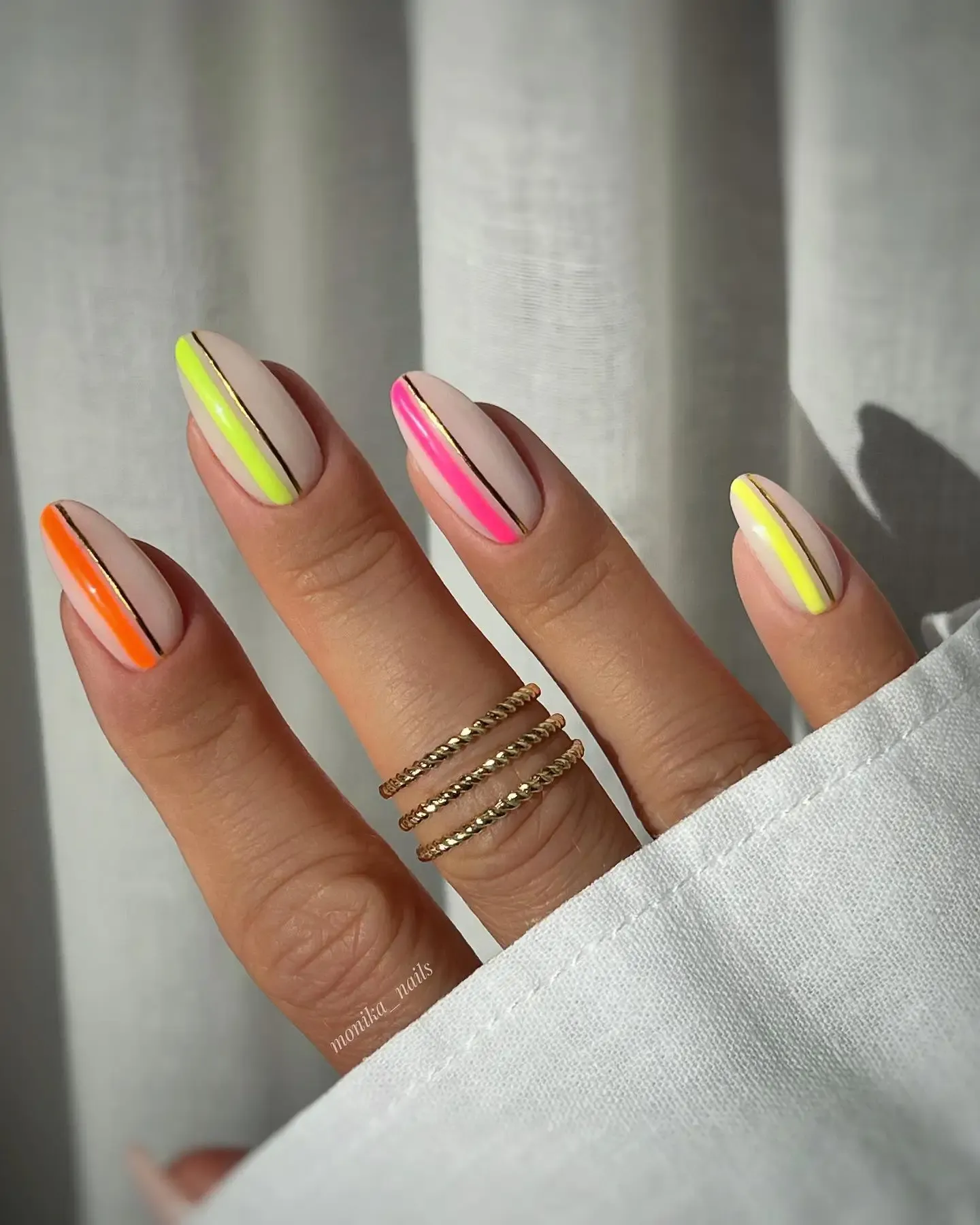 Clear nails with neon stripes.