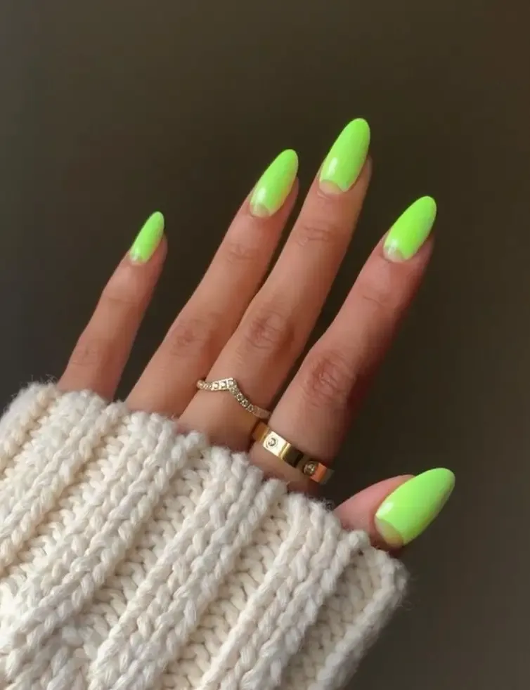 Neon green nails with half moons.