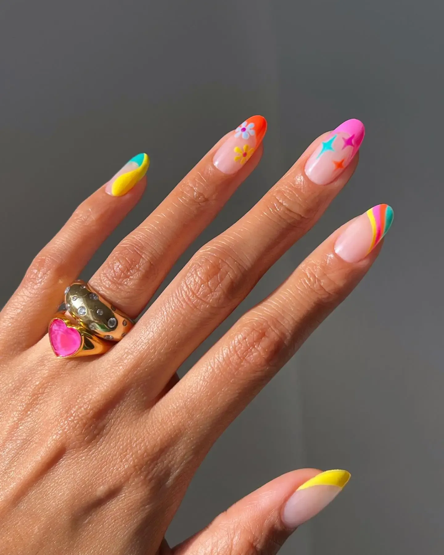 Neon rainbow nails with French tips.