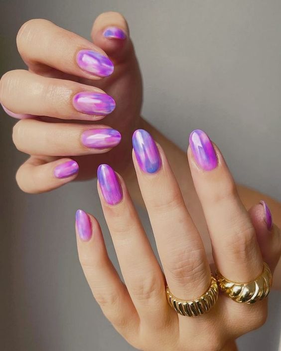 Glossy purple marble nail design on medium round nails