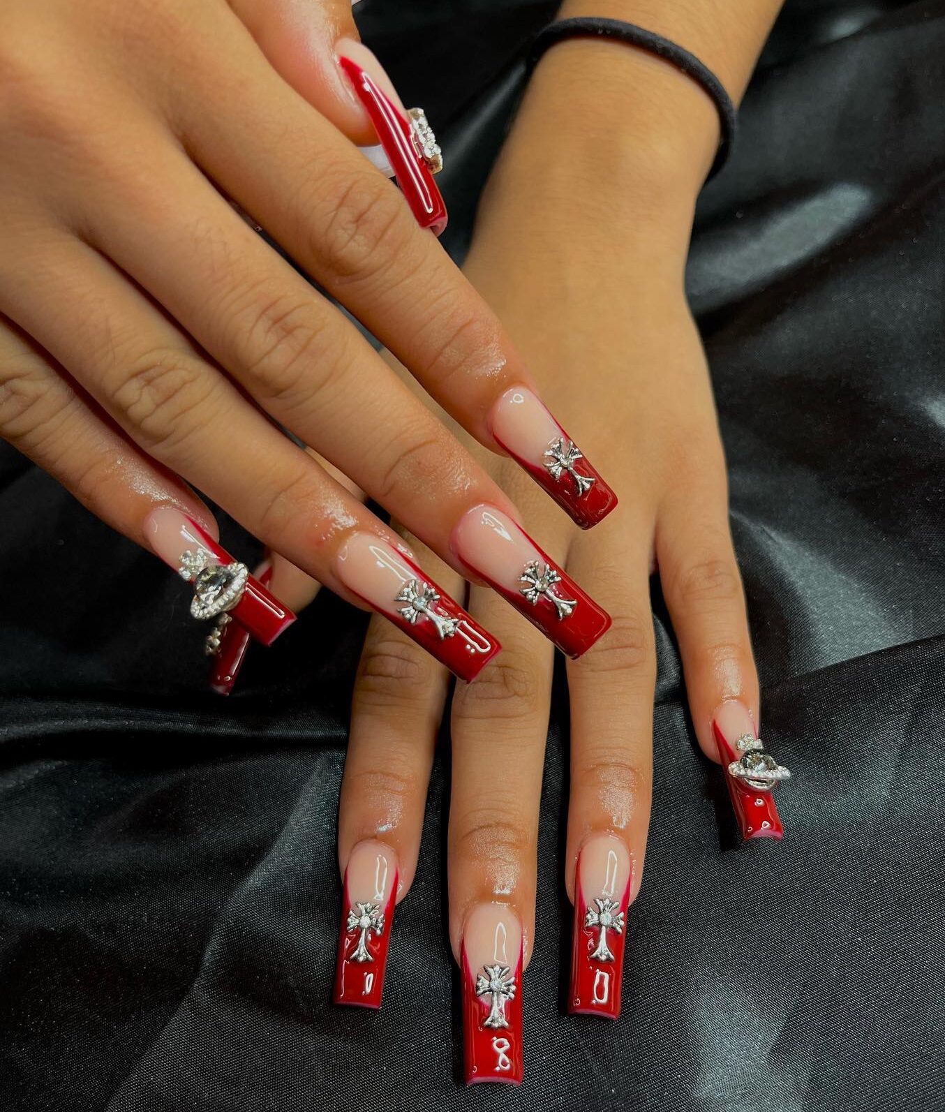 Dark red French tips with goth bling nail design on long square shaped acrylic nails