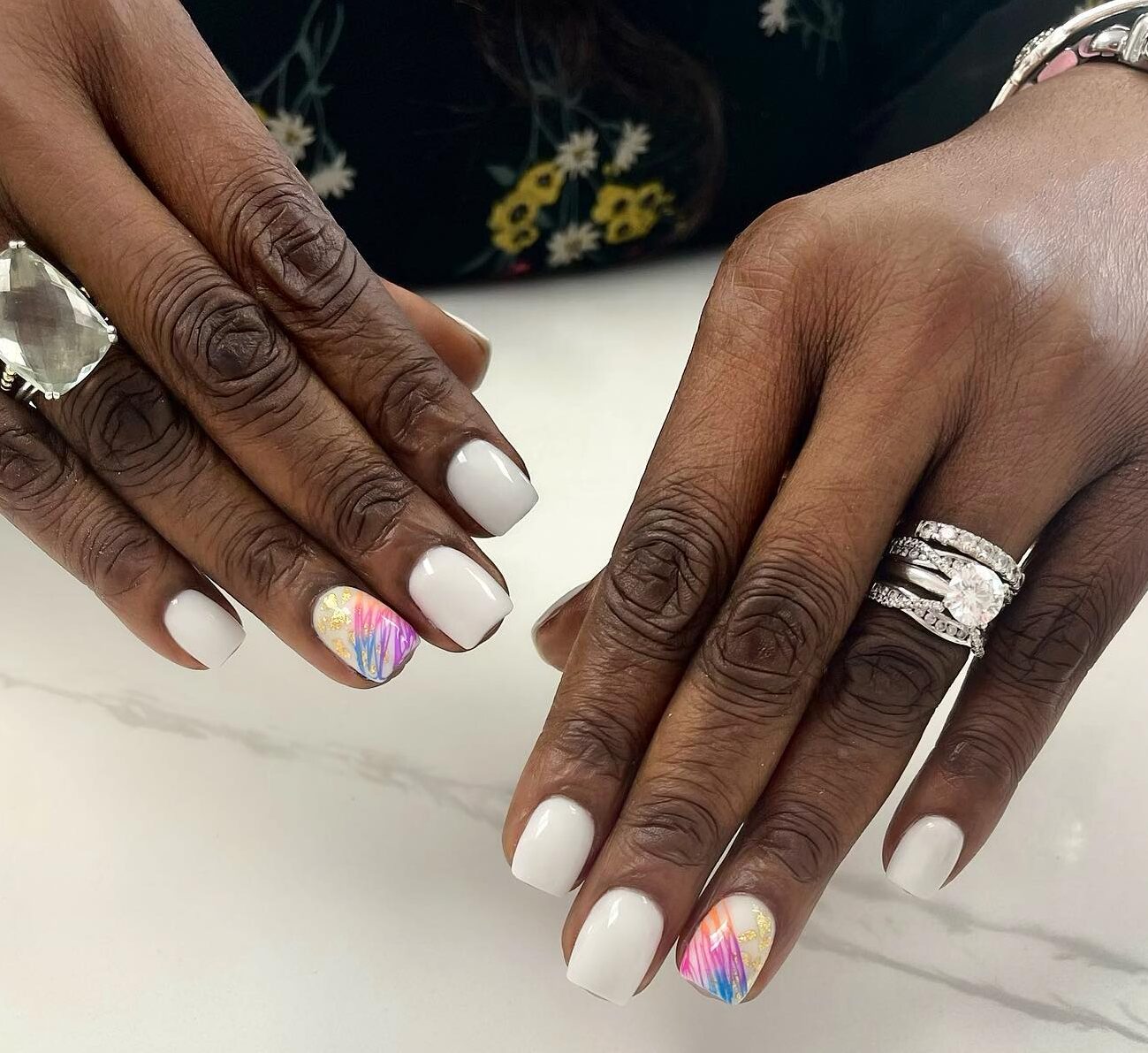 Pristine white nail color with colorful geometric pattern and gold foil nail arts on short square nails