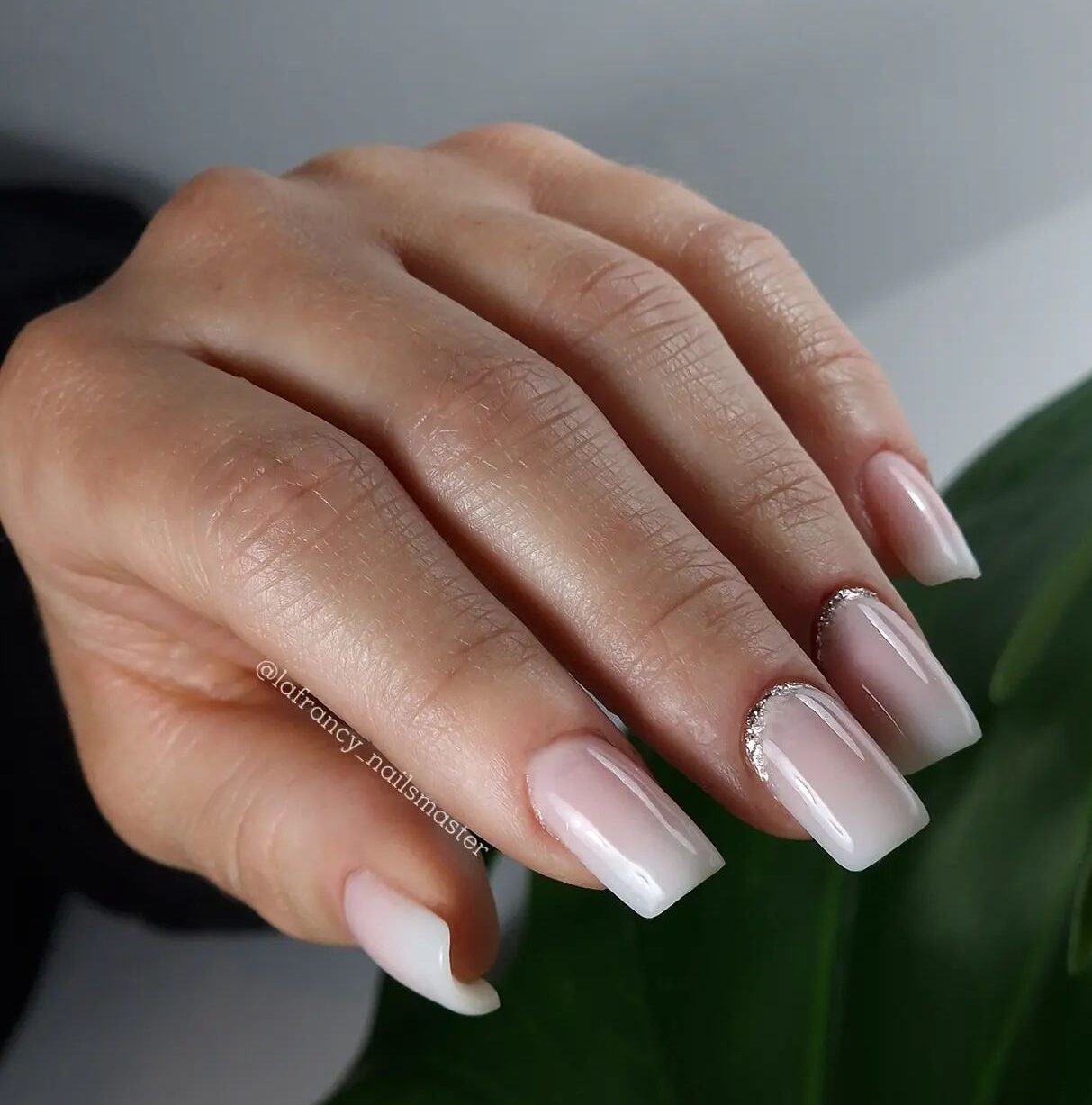 Pale white nail polish on medium square nails