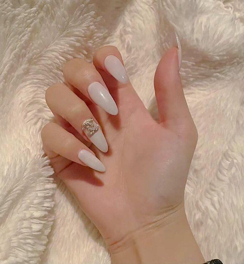 Pale white nail color with bling on long almond shaped press on nails